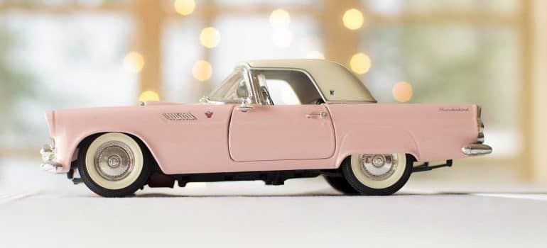 A pink model of an antique car.