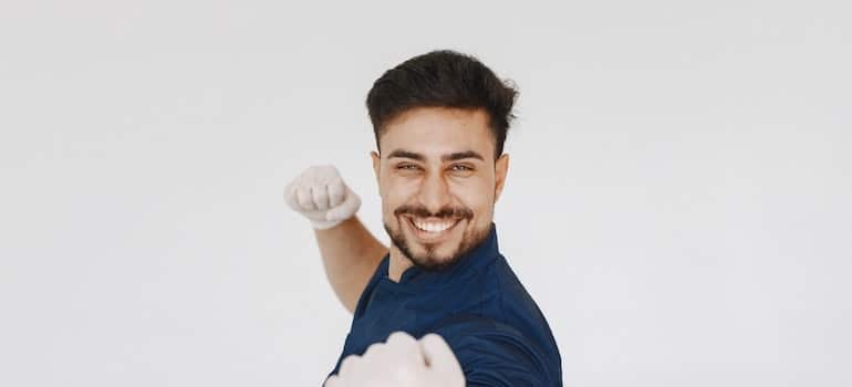 Smiling man in white gloves