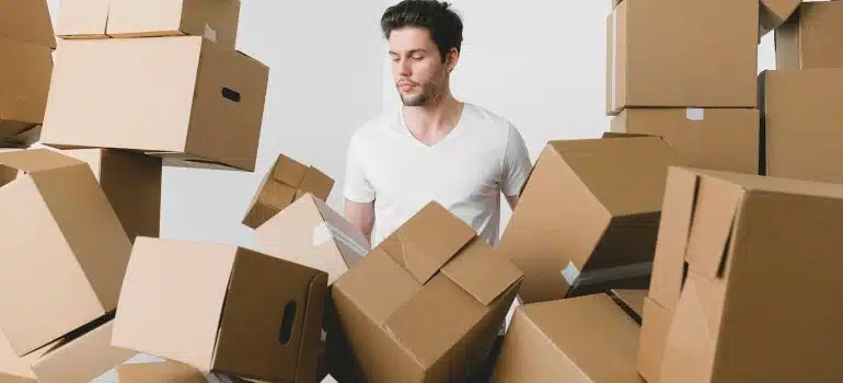 a man surrounded by a lot of boxes